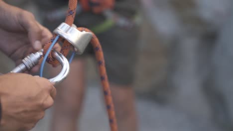 climber preparing for climbing up the mountain by checking his rope