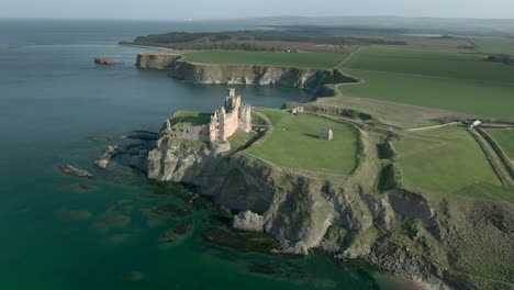 An-aerial-view-of-the-side-and-front-of-Tantallon-Castle-ruin-on-a-sunny-day,-East-Lothian,-Scotland