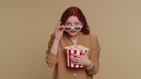 woman in 3d glasses with popcorn at the cinema