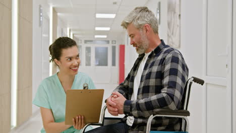 nurse consulting with patient in wheelchair