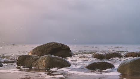 the sea waves wash away the big stones