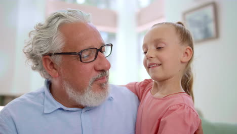 Abuelo-Sonriente-Mirando-A-Su-Nieta.-Chica-Abrazando-A-Un-Hombre-Mayor-En-La-Habitación