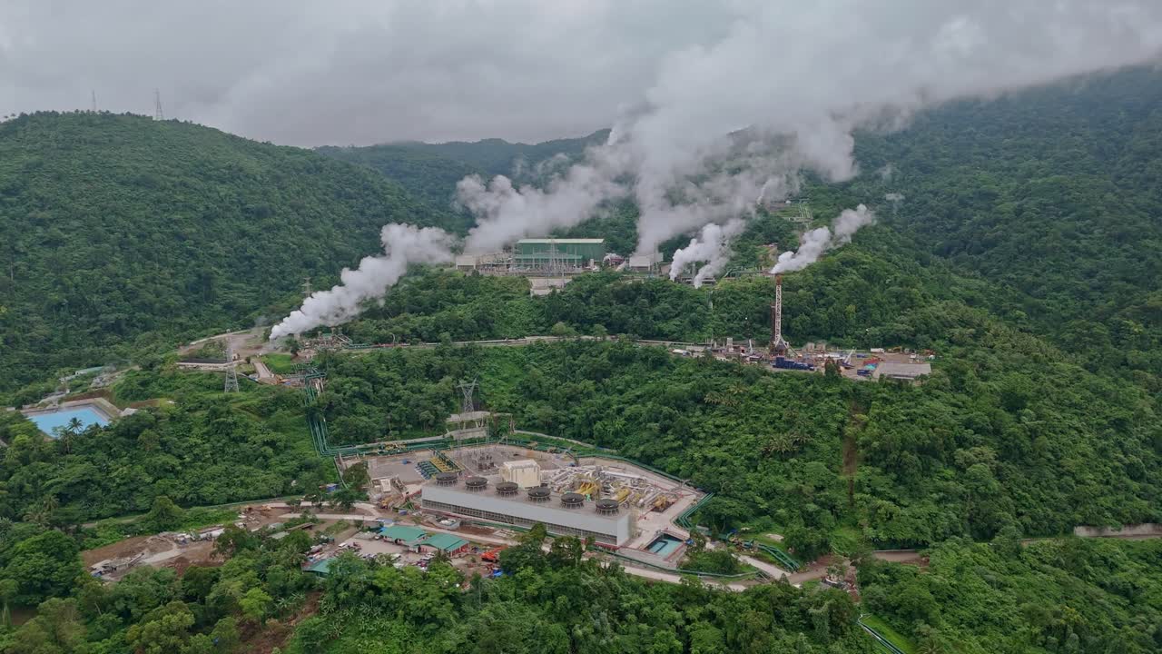 Birds eye view over geothermal power plants nestled in the volcanic mountains above Ormoc City, Leyte, Philippines.