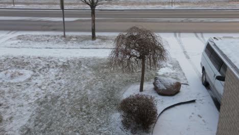 a fresh snowfall in front of a suburban house