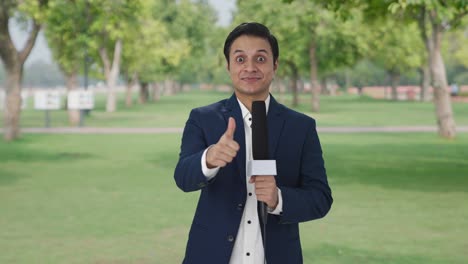 happy indian reporter showing thumbs up