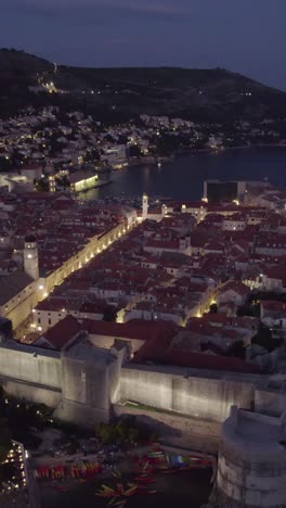 aerial view of the old town of dubrovnik, croatia, glowing at dusk. vertical video