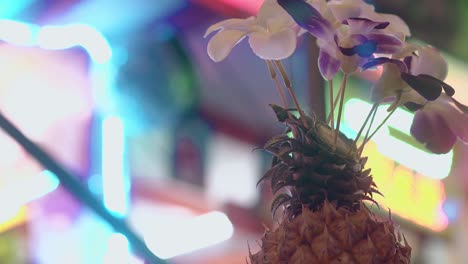 table-decoration-with-beautiful-flowers-against-neon-lights