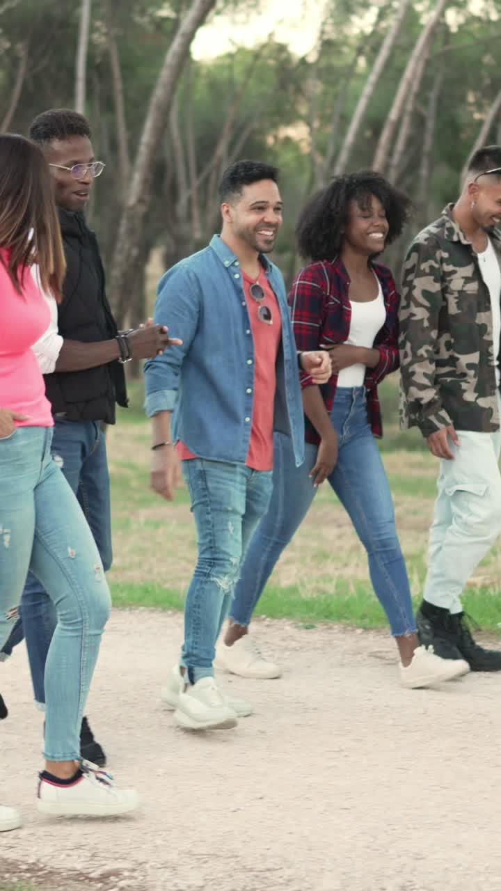 Diverse group of friends walking and talking outdoors