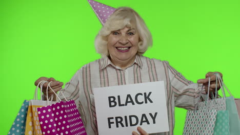 Inscription-advertising-Black-Friday-appears-next-to-joyful-grandmother-with-shopping-bags