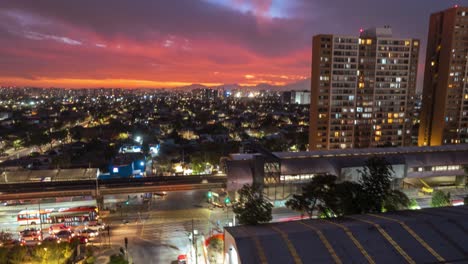 Aerial-hyperlapse-establishing-of-a-high-altitude-subway-station-with-the-sunset-in-the-background,-Santiago-Chile