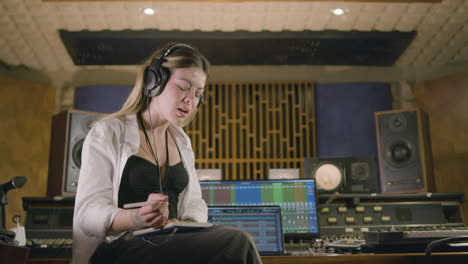 Young-Caucasian-woman-working-at-music-recording-studio