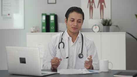 sad indian doctor giving medicine to patient