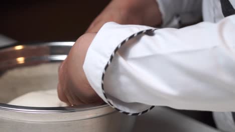 kneading white dough with hands placing for resting formenting