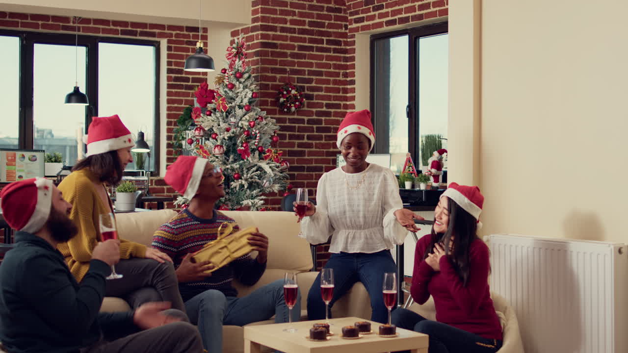 Multiethnic group of people exchanging gifts at winter festivity