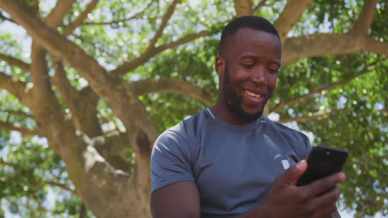 Man training in an urban setting taking a break