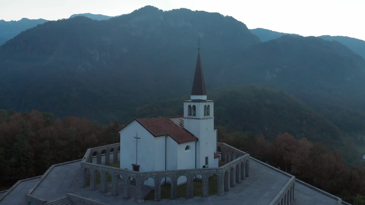 italian charnel house in Kobarid, drone flies near, closeup aerial shot on misty spring morning