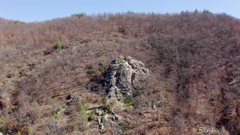 Drone-panning-around-the-slopes-of-Skribina,-a-place-known-for-its-healing-powers-located-along-the-Rhodope-Mountains-in-Bulgaria