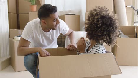 smiling young woman in a cardboard carton