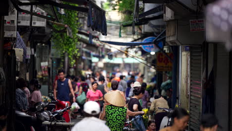 crowd of residents in the narrow streets of hanoi, selective focus