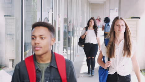 College-Students-Walking-Along-Campus-Corridor-Between-Lessons