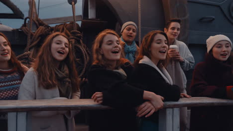Young Women Singing on a Ship Deck