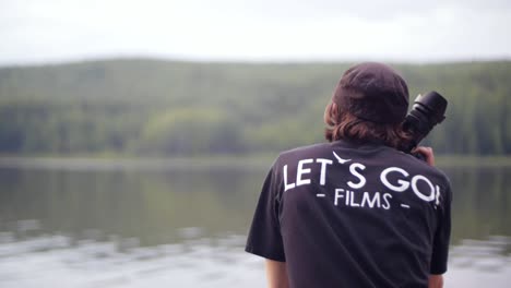 photographer by the lake in the forest