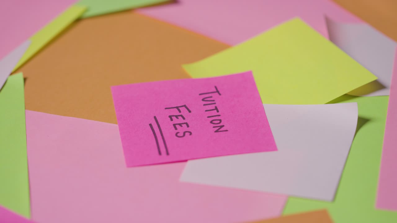 Education Concept Of Revolving Sticky Notes With Tuition Fees Written On Top Note 1