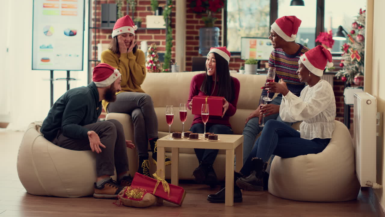 Work colleagues celebrating christmas eve with gifts