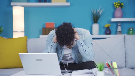 a university student who is stressed by what he sees on the laptop.