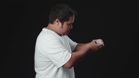 asian magician starts showing his trick with cards, cards cascading down