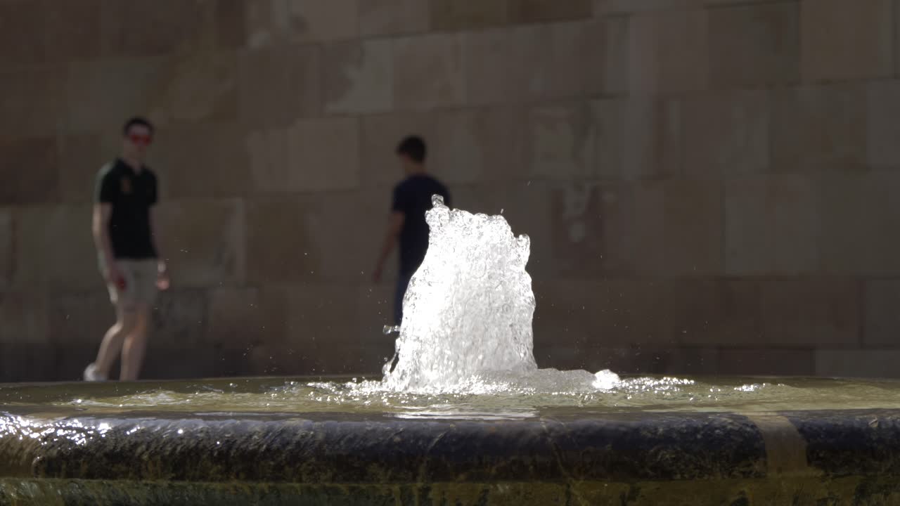 Slow motion water fountain in 4k with people in the background in Murcia Spain