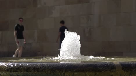 slow motion water fountain in 4k with people in the background in murcia spain