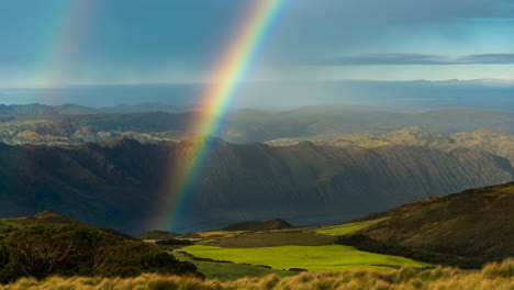 a vibrant rainbow arches over majestic mountains and green valleys