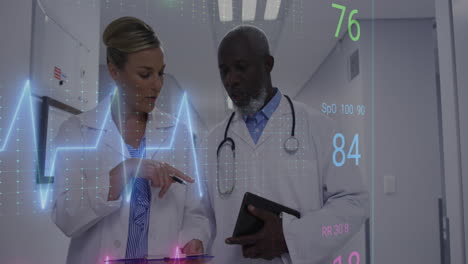 animation of heart rate monitor against diverse male and female doctors discussing at hospital