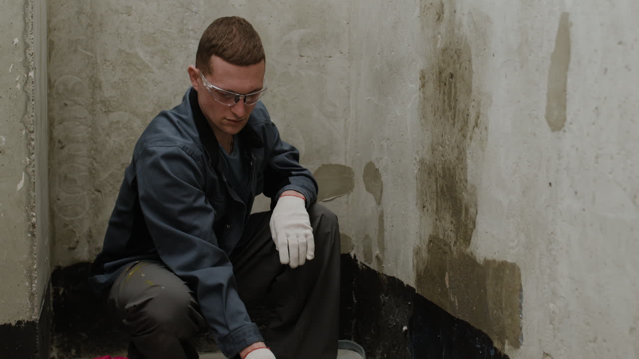 Painter Applying Primer to a Wall