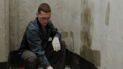 painter applying primer to a wall