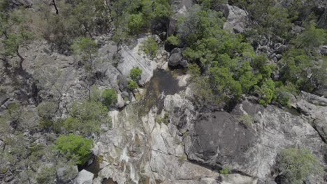 Top-down-View-Of-Water-Cascades-At-Emerald-Creek-Falls-In-Mareeba,-Australia-At-Daytime---aerial-drone-shot