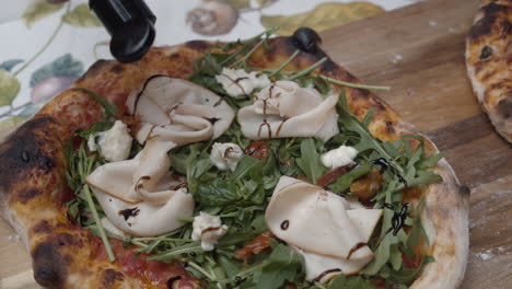 chef puts sauce on top of neapolitan pizza topping