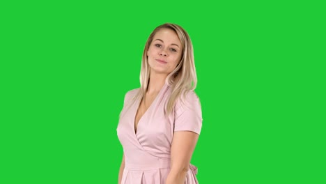 pretty woman showing her dress to the camera on a green screen, chroma key