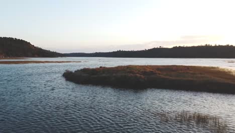 low-angle aerial flight over milfontes shoreline at magic hour