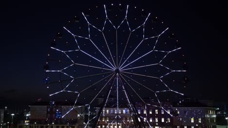 accelerated. ferris wheel with glowing multicolored lights against the night sky