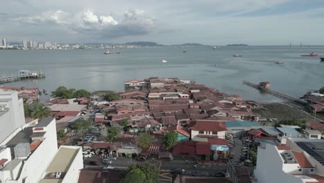 flyover: jumble of buildings on chew jetty in george town, malaysia