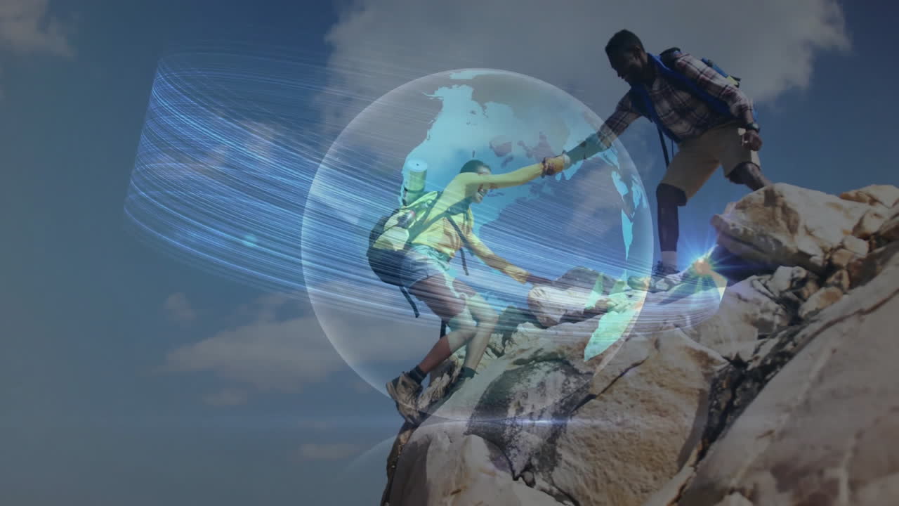 Two hikers pulling each other up rocky ledge under open sky, featuring technology globe overlay