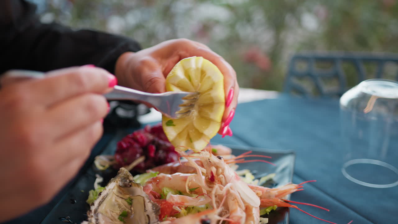 Woman Squeezing A Lemon With The Fork During Lunch At The Beach Resort