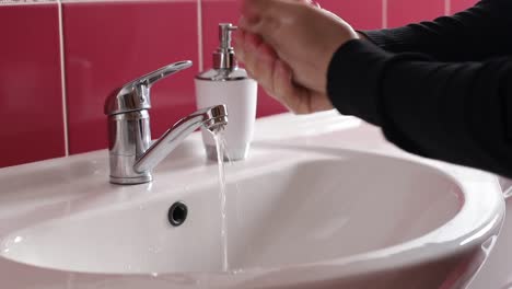 african man drying his hands after washing hands corona virus