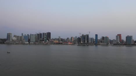 Baia-de-Luanda-in-the-twilight,-drone-flight-over-the-water