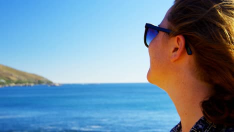 woman having beer in the beach 4k