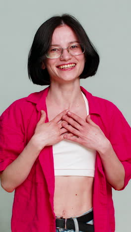 young woman laughing loudly covering mouth with hand genuine sincere amused emotional happy reaction