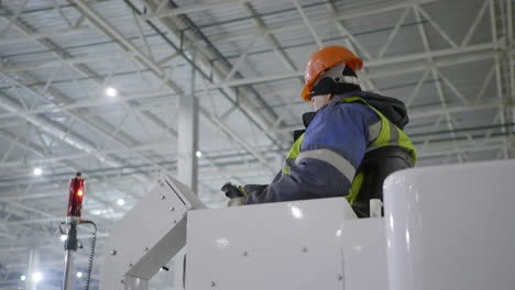 worker operating industrial vehicle in warehouse