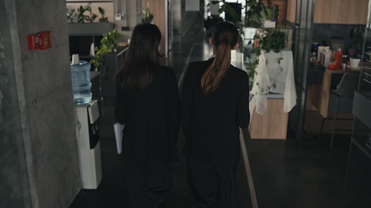 Businesswomen Walking in an Office Hallway